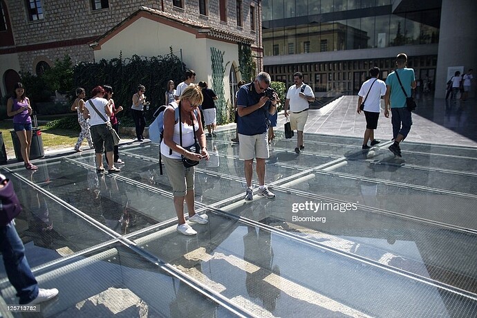 tourists-take-photographs-of-ancient-ruins-through-a-glass-floor_1634861128872