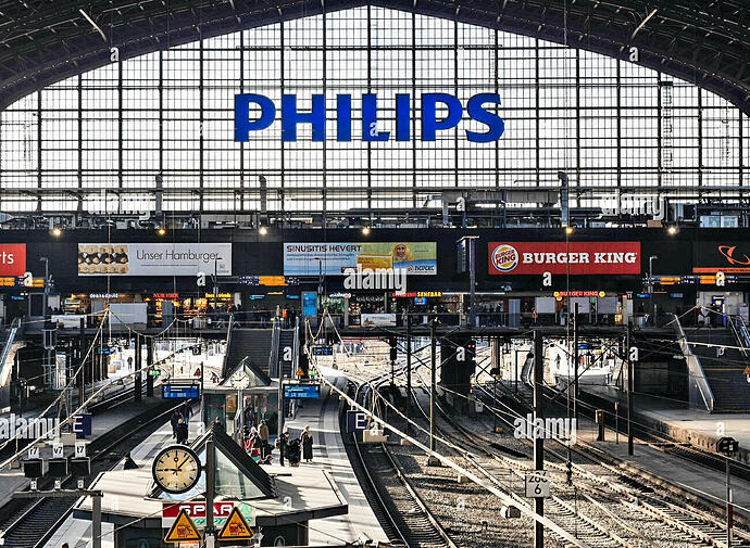 hamburg-germany-mar-20-2018-hamburg-hauptbahnhof-wide-interior-with-elevate-view-of-trains-people-traveling-and-huge-philips-advertisement-RRX067